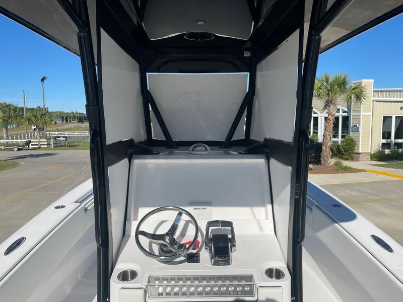 Slide: The Image of 2024 Invincible 33 Open Fisherman boat console with steering wheel and controls. - 22