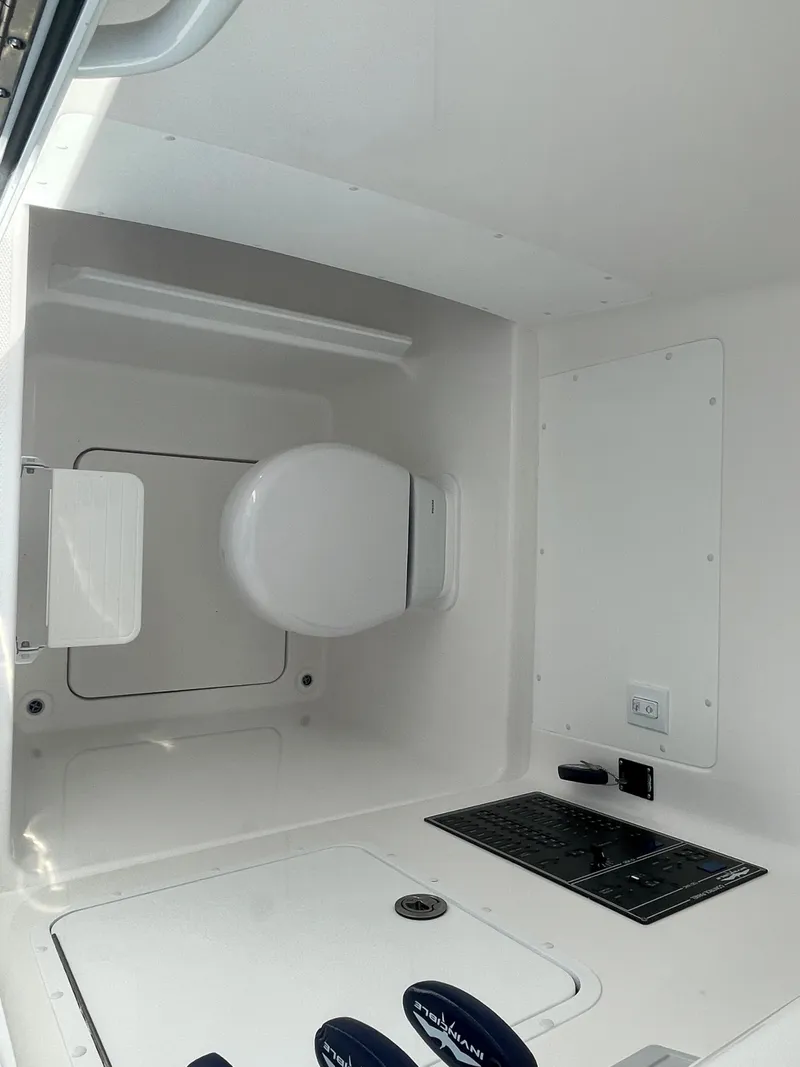 Slide: The Image of 2024 Invincible 33 Open Fisherman boat interior with toilet and control panel. - 32