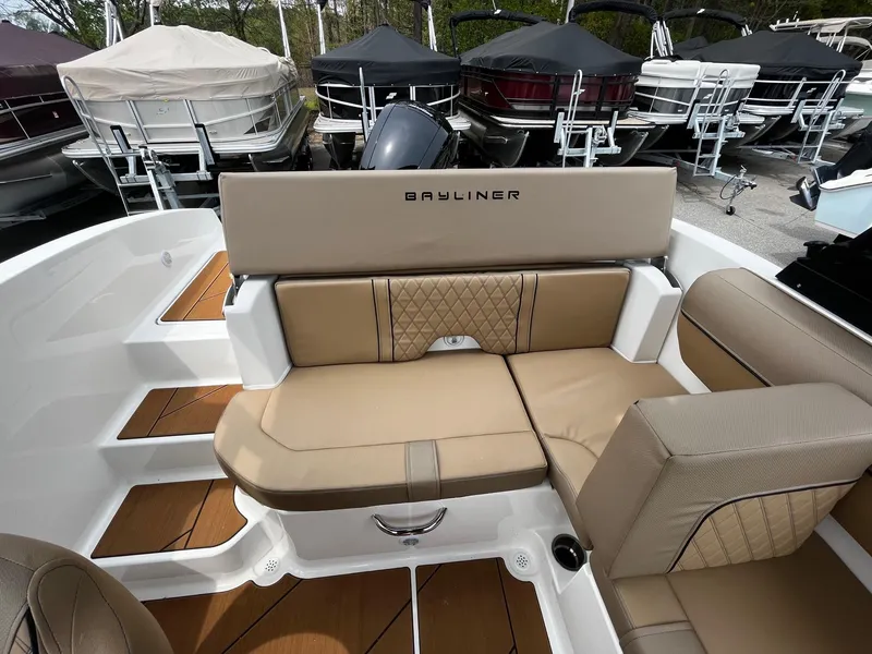 Slide: The Image of 2024 Bayliner DX2000 boat interior with tan seating and backrest. - 10