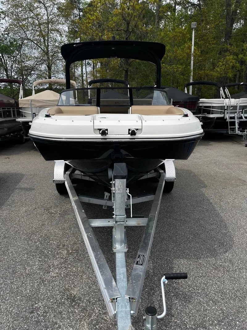 Slide: The Image of 2024 Bayliner DX2000 boat on trailer, front view, in outdoor lot. - 4