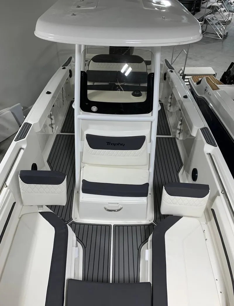 Slide: The Image of 2024 Bayliner Trophy 24 CC center console boat with cushioned seating and modern design. - 3