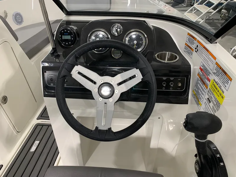 Slide: The Image of 2024 Bayliner VR4 boat dashboard with steering wheel and control panel. - 8