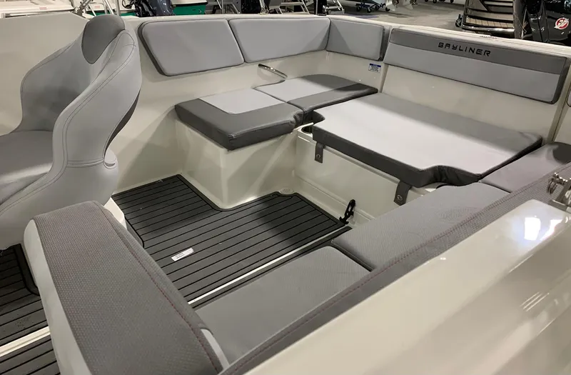 Slide: The Image of 2024 Bayliner VR4 boat interior with gray seating and black flooring. - 9