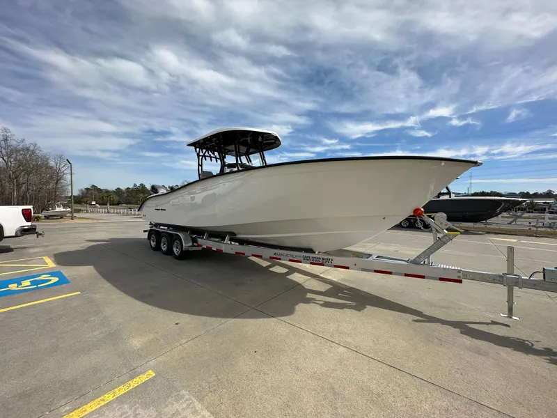 Slide: The Image of 2024 Cape Horn 32 XS boat on a trailer under a partly cloudy sky. - 6