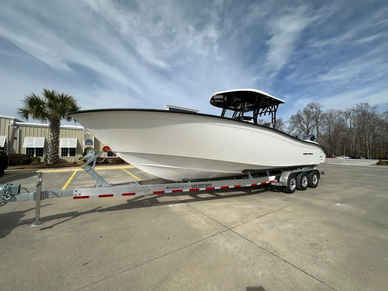 Slide: The Image of 2024 Cape Horn 32 XS boat on a trailer in a parking lot. - 1