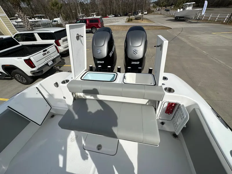 Slide: The Image of 2024 Cape Horn 32 XS boat with dual Suzuki 350 engines in a parking lot. - 11