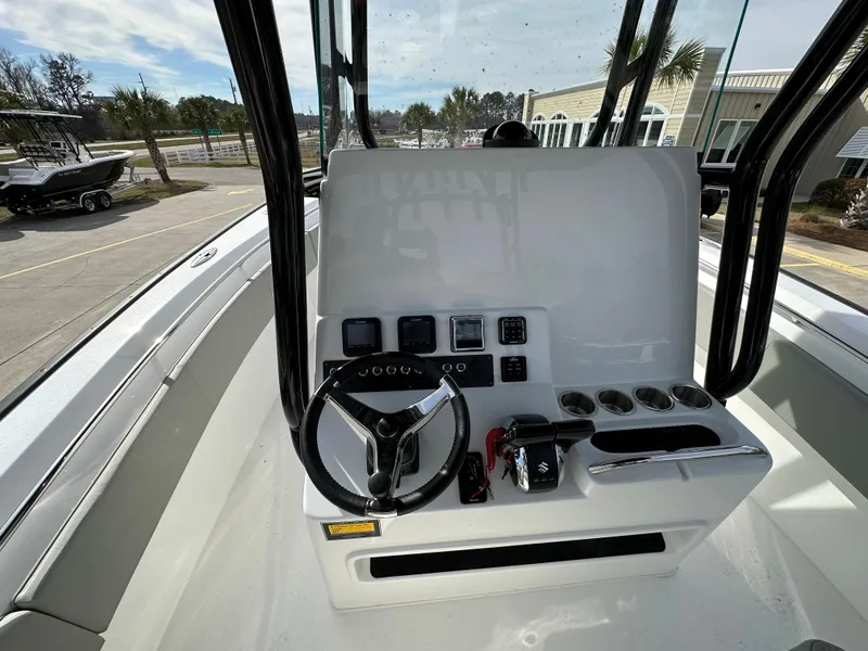 Slide: The Image of 2024 Cape Horn 32 XS boat console with steering wheel and controls. - 19
