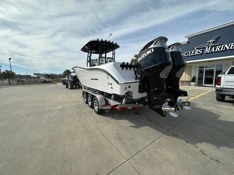 Slide: The Image of 2024 Cape Horn 32 XS boat with dual Suzuki engines on a trailer at Anglers Marine. - 2