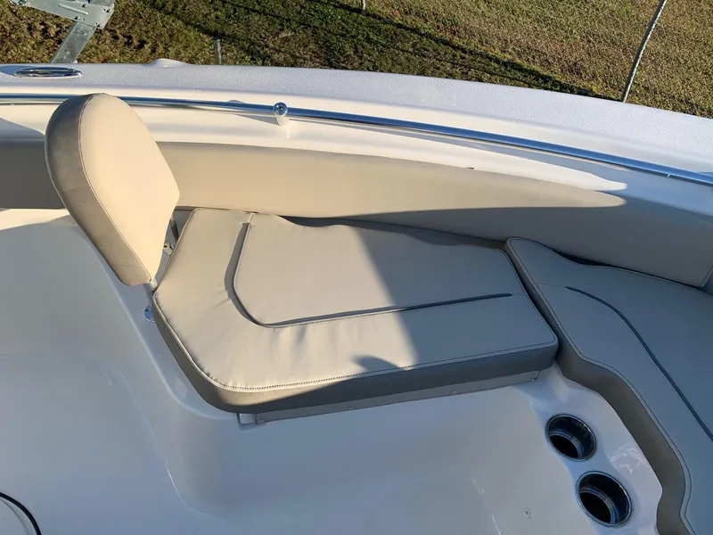 Slide: The Image of 2024 Key West 219 FS boat with cushioned seating and cup holders. - 20