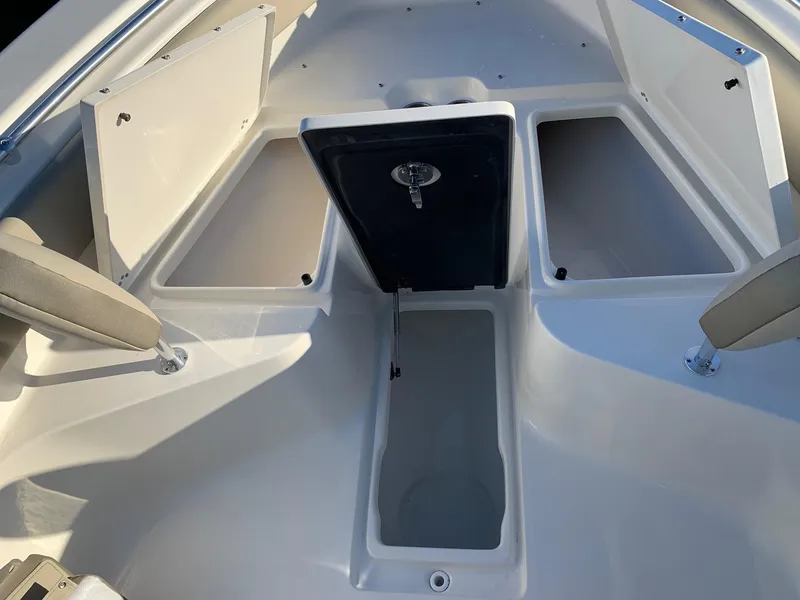 Slide: The Image of 2024 Key West 239 FS boat storage compartments and seating area. - 15