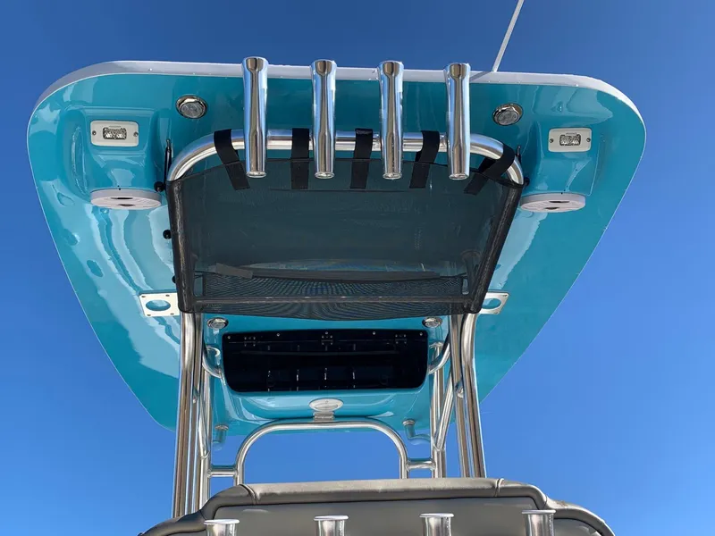 Slide: The Image of 2024 Key West 239 FS boat T-top with rod holders against blue sky. - 19