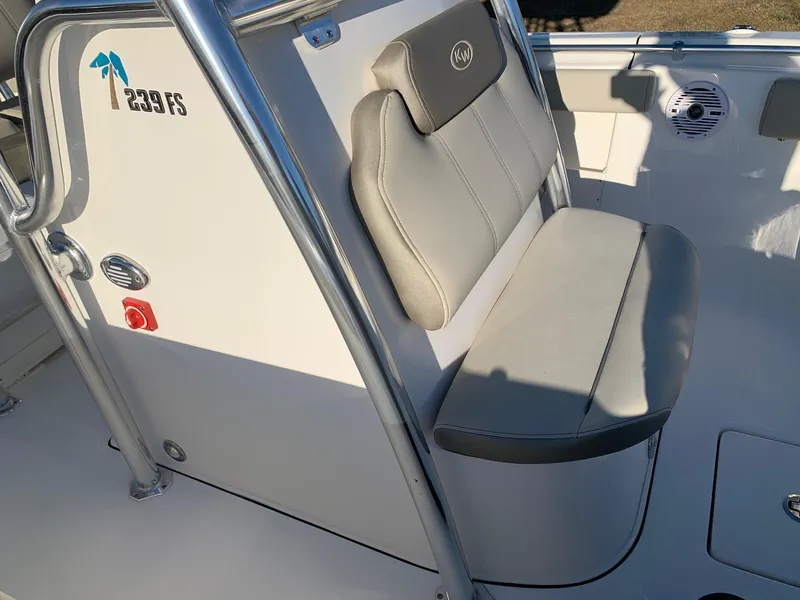 Slide: The Image of 2024 Key West 239 FS boat interior with cushioned seating and console. - 8