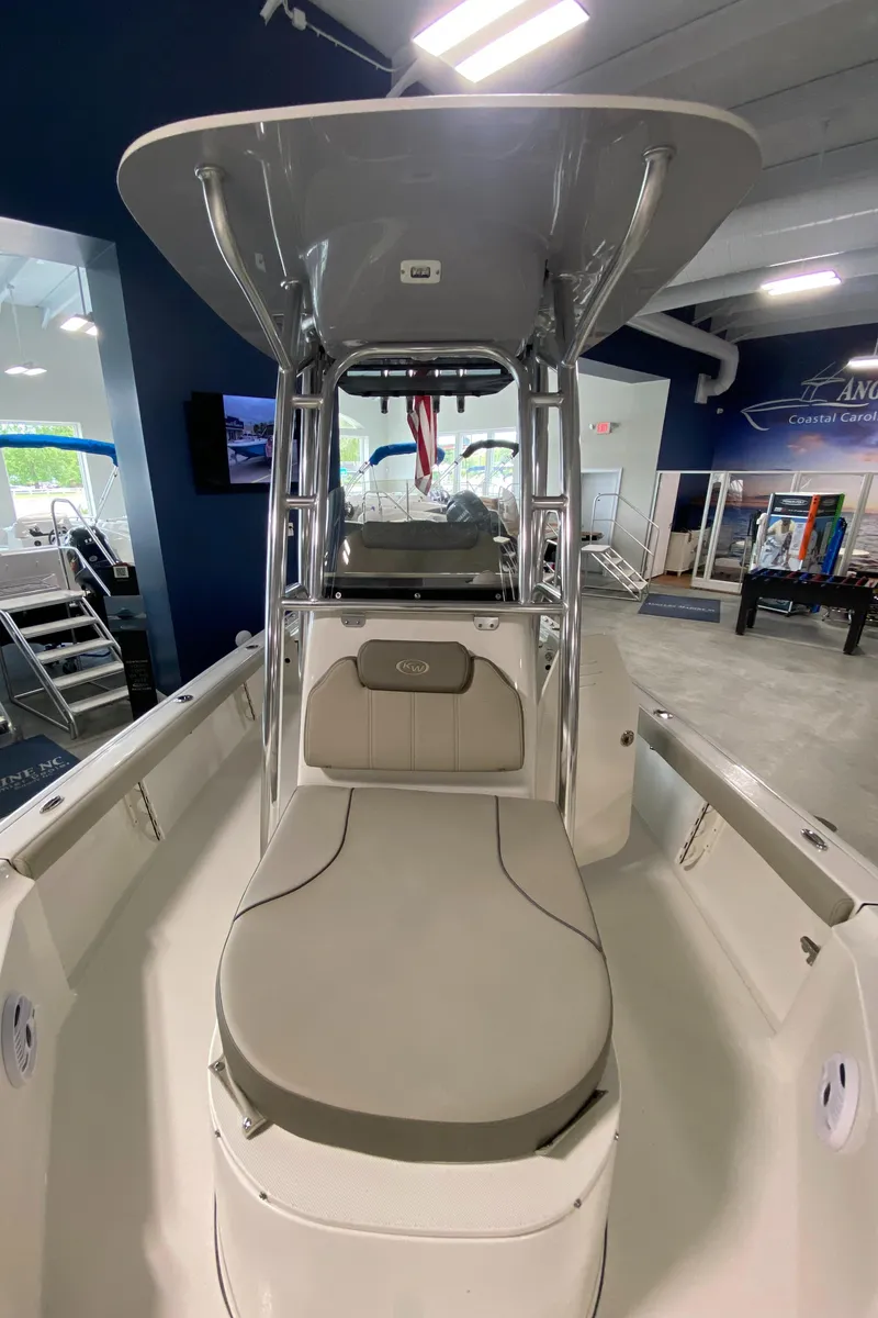 Slide: The Image of 2024 Key West 250 Bay Reef boat interior with seating and console. - 23