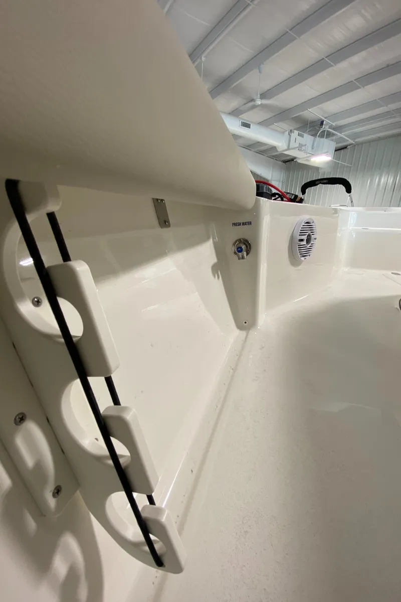 Slide: The Image of 2024 Key West 250 Bay Reef interior detail showing rod holders and speaker. - 25