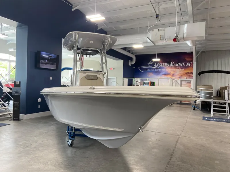 Slide: The Image of 2024 Key West 250 Bay Reef boat displayed in showroom. - 3