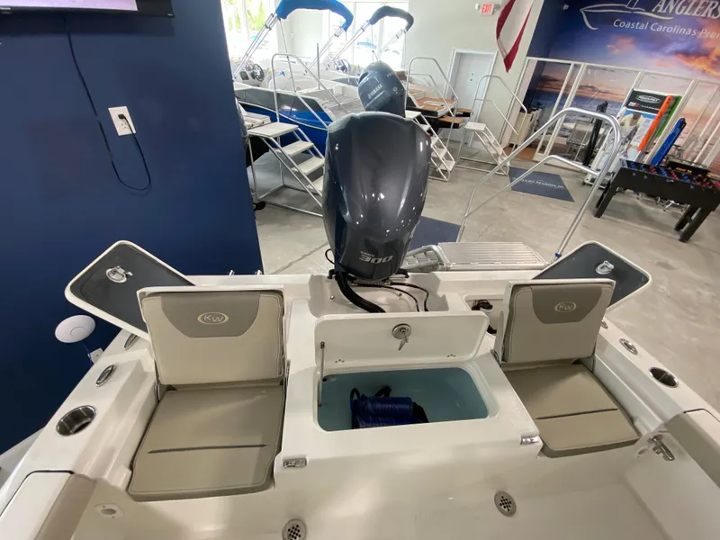Slide: The Image of 2024 Key West 250 Bay Reef boat interior with motor and seating. - 8