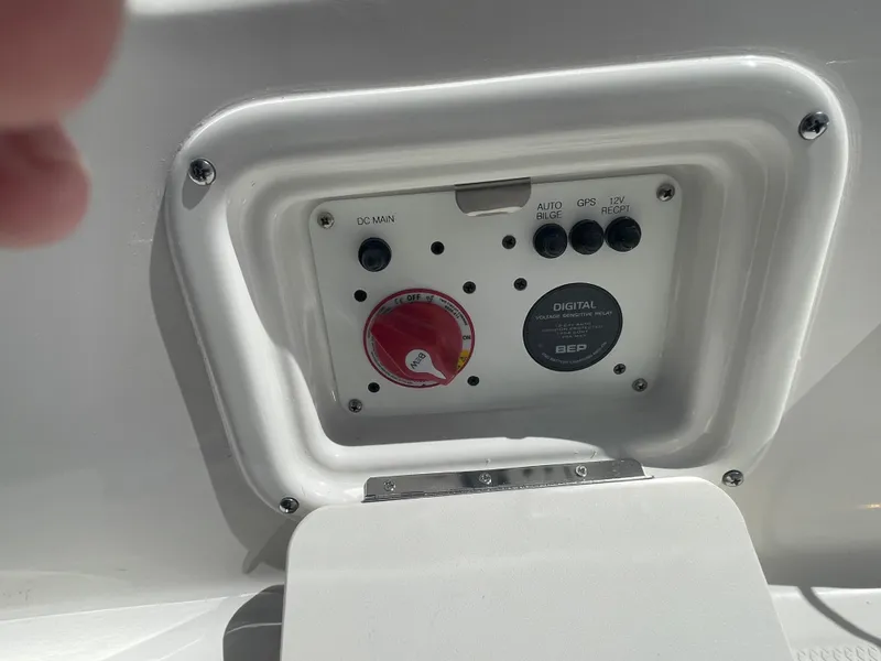 Slide: The Image of Control panel of a 2024 Robalo 226 Cayman boat with switches and dials. - 10