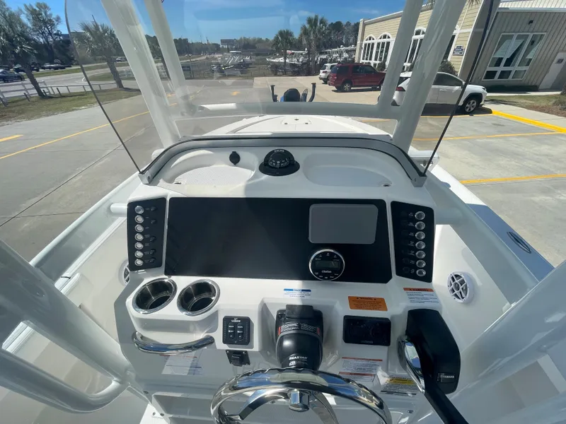 Slide: The Image of 2024 Robalo 226 Cayman boat console with steering wheel and controls. - 11