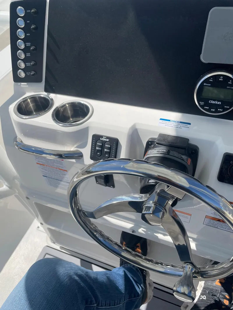 Slide: The Image of 2024 Robalo 226 Cayman boat console with steering wheel and controls. - 12