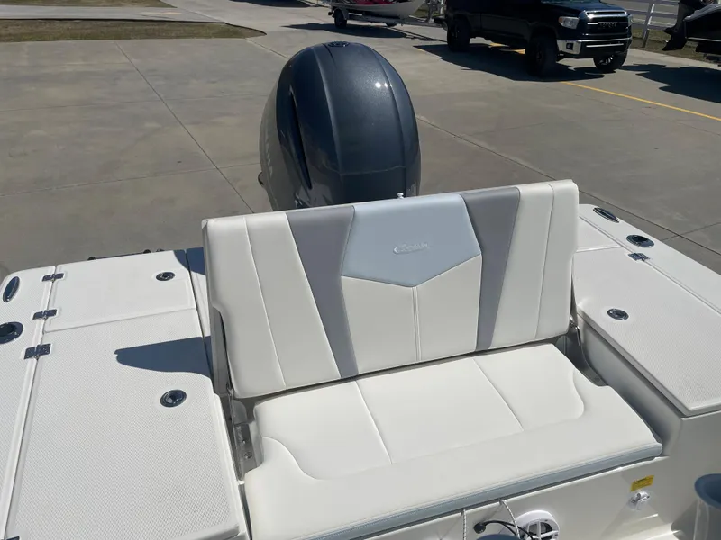 Slide: The Image of 2024 Robalo 226 Cayman boat with white seating and outboard motor. - 15