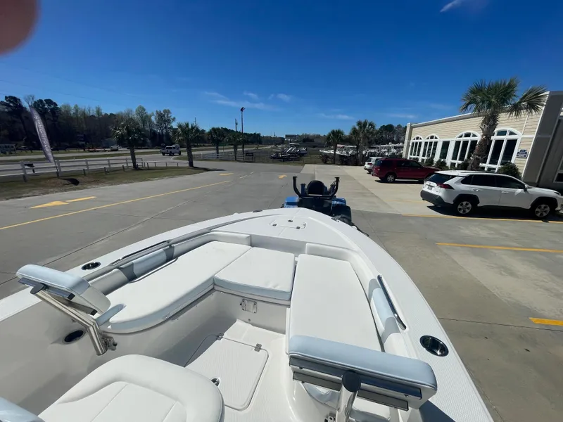 Slide: The Image of 2024 Robalo 226 Cayman boat on trailer in parking lot. - 18