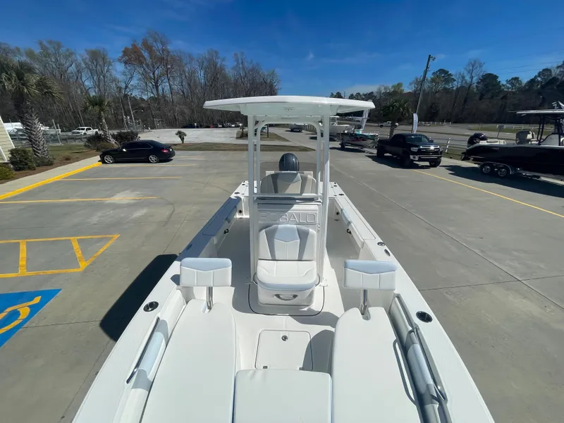 Slide: The Image of 2024 Robalo 226 Cayman boat on display in a parking lot. - 19