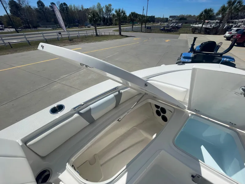 Slide: The Image of 2024 Robalo 226 Cayman boat storage compartments and seating area. - 23