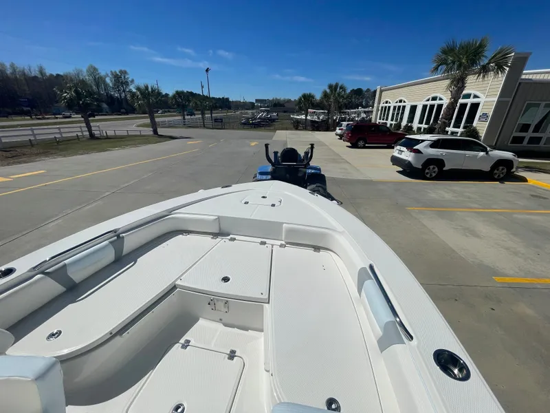 Slide: The Image of 2024 Robalo 226 Cayman boat on trailer in parking lot, sunny day. - 24