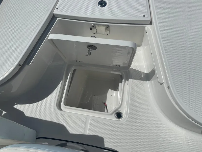 Slide: The Image of 2024 Robalo 226 Cayman boat storage compartment open. - 25