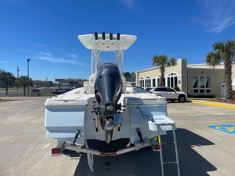 Slide: The Image of 2024 Robalo 226 Cayman boat, rear view, parked outdoors on a sunny day. - 3