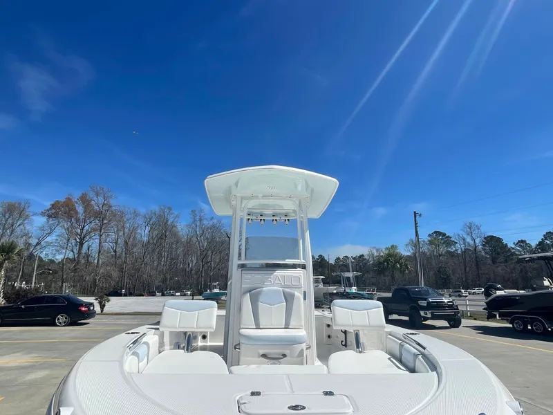 Slide: The Image of 2024 Robalo 226 Cayman boat in a parking lot under a clear blue sky. - 6