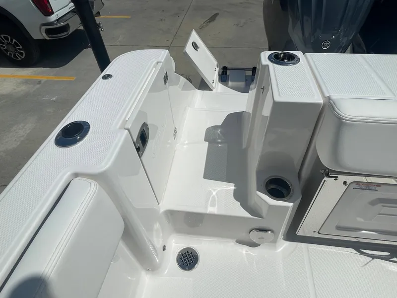 Slide: The Image of 2023 Robalo 270 boat deck with storage compartments and rod holders. - 12