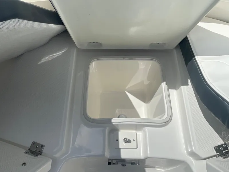 Slide: The Image of 2023 Robalo 270 boat storage compartment with open lid. - 25