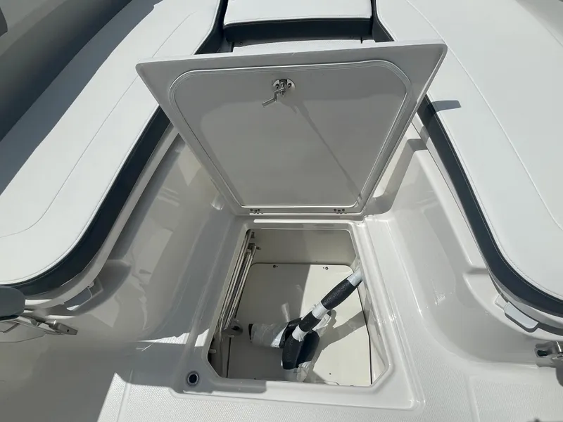 Slide: The Image of 2023 Robalo 270 boat storage compartment with open hatch. - 26