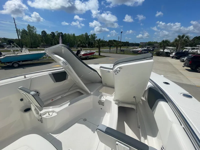 Slide: The Image of 2023 Robalo 270 boat with open storage compartments and seating. - 27