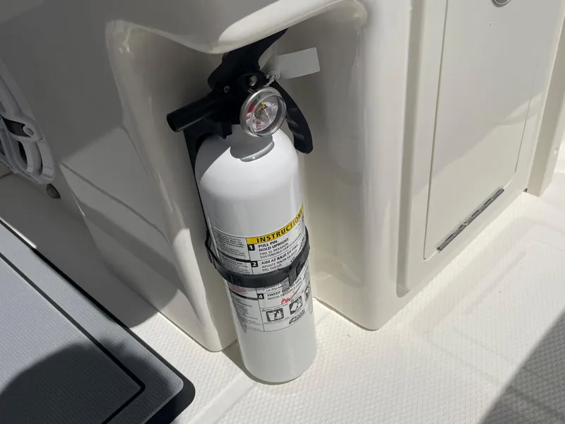 Slide: The Image of Fire extinguisher mounted on a 2023 Robalo 270 boat. - 29