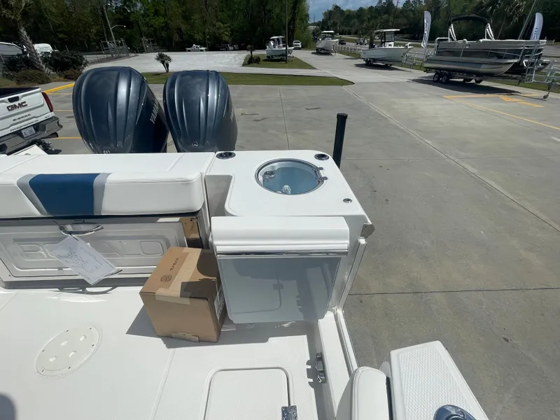 Slide: The Image of 2023 Robalo 270 boat with dual outboard engines and deck storage. - 30