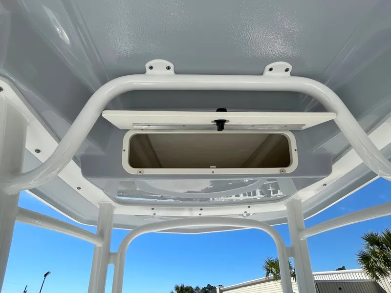 Slide: The Image of 2024 Robalo R222 Center Console storage compartment under T-top. - 11