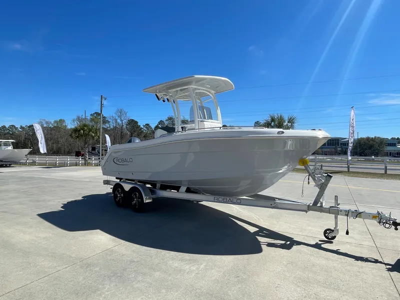 Slide: The Image of 2024 Robalo R222 Center Console boat on a trailer in a parking lot. - 4