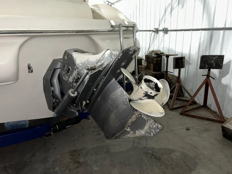 Slide: The Image of 2002 Larson Escape 213 boat propeller and stern drive in a garage. - 11