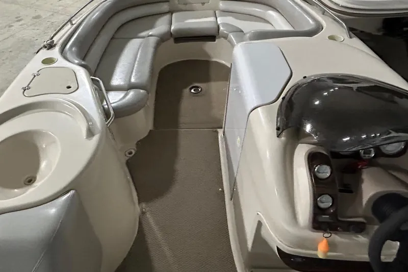 Slide: The Image of 2002 Larson Escape 213 boat interior with seating and control console. - 21