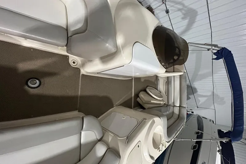 Slide: The Image of 2002 Larson Escape 213 boat interior with white and gray seating. - 22
