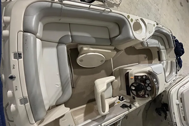 Slide: The Image of 2002 Larson Escape 213 boat interior with seating and steering console. - 24