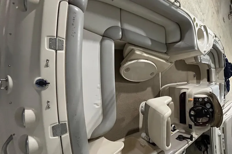 Slide: The Image of 2002 Larson Escape 213 boat interior with seating and steering console. - 25