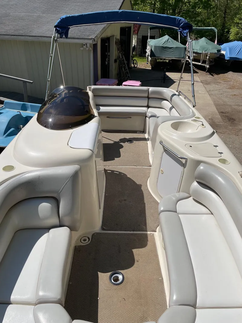 Slide: The Image of 2002 Larson Escape 213 boat with spacious seating and canopy. - 4