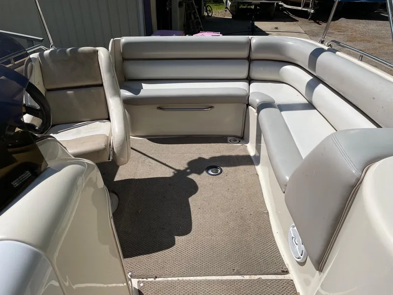 Slide: The Image of 2002 Larson Escape 213 boat interior with beige seating and carpet. - 5