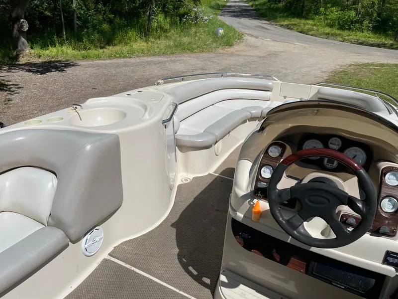 Slide: The Image of Interior of a 2002 Larson Escape 213 boat with seating and steering console. - 8