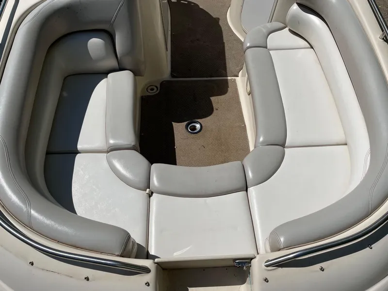 Slide: The Image of 2002 Larson Escape 213 boat interior with cushioned seating and carpeted floor. - 9