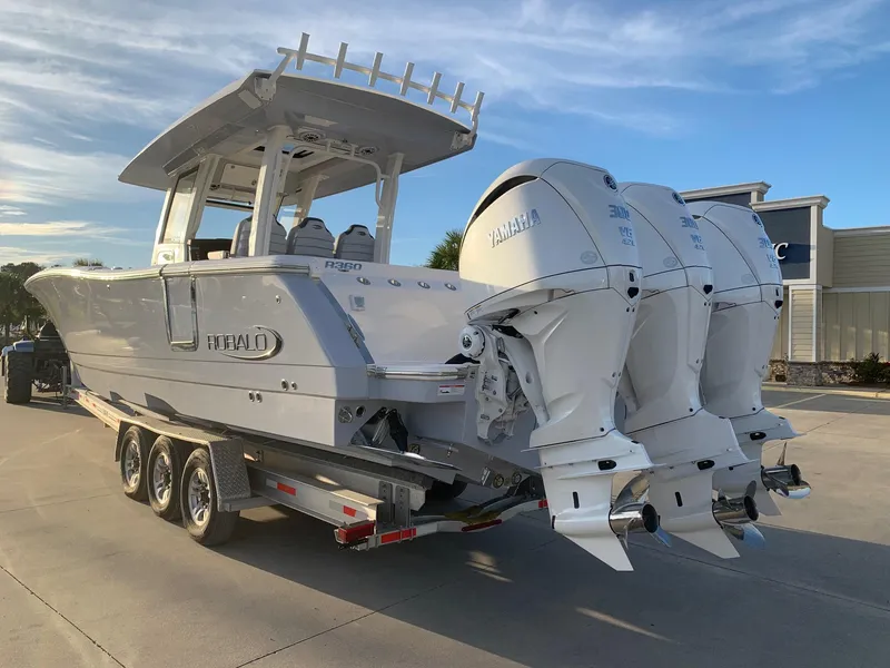 Slide: The Image of 2024 Robalo R360 boat with triple Yamaha engines on a trailer. - 2