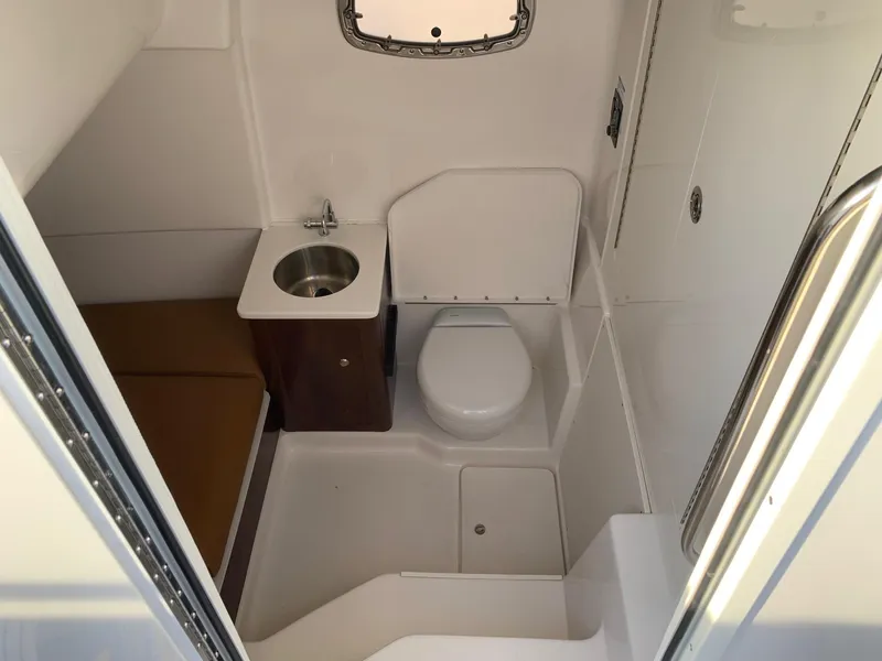 Slide: The Image of 2024 Robalo R360 boat interior bathroom with sink and toilet. - 22